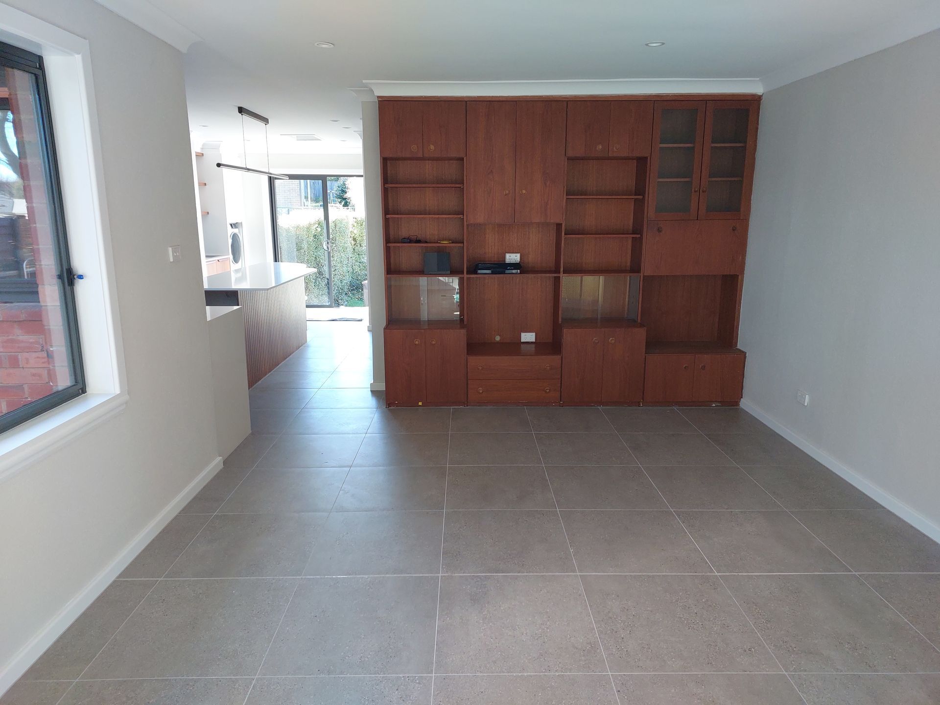 Empty Room With Wooden Built-in Cabinets and Shelves; Tiled Floor — Elimar Construction in Goulburn, NSW