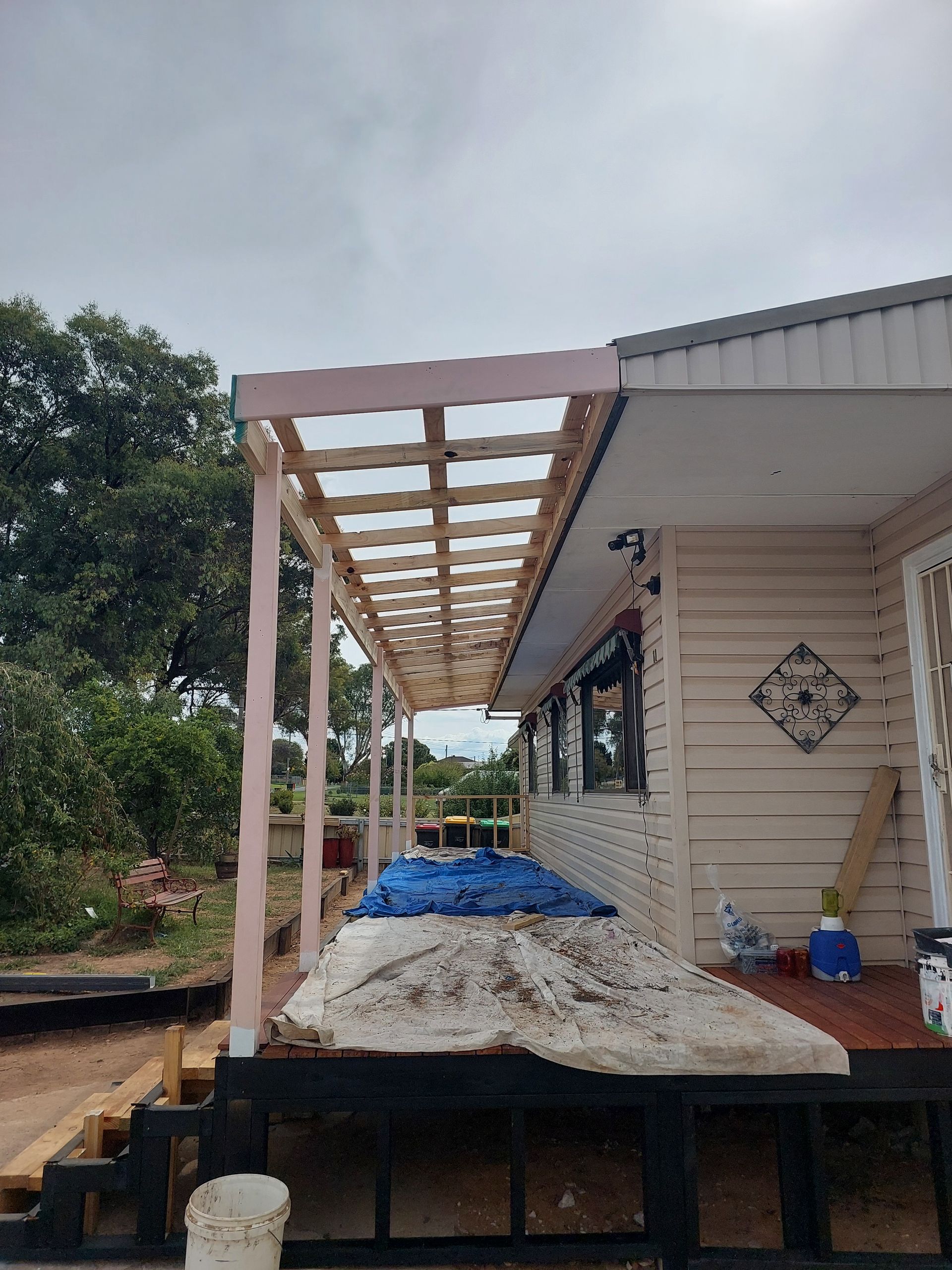 A White House With a Wooden Porch Under Construction — Elimar Construction in Goulburn, NSW
