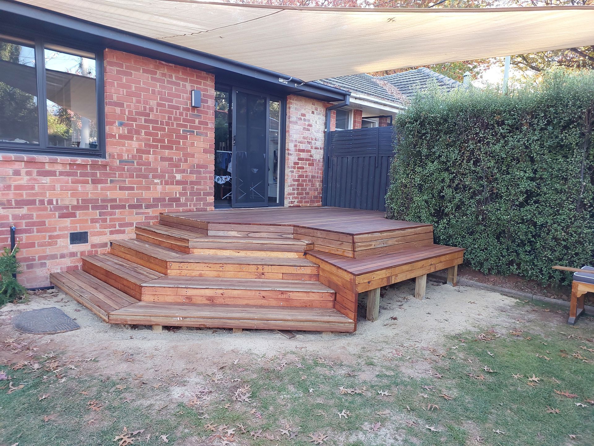 Wooden Deck With Steps Leading to a Sliding Glass Door of a Brick Building — Elimar Construction in Goulburn, NSW