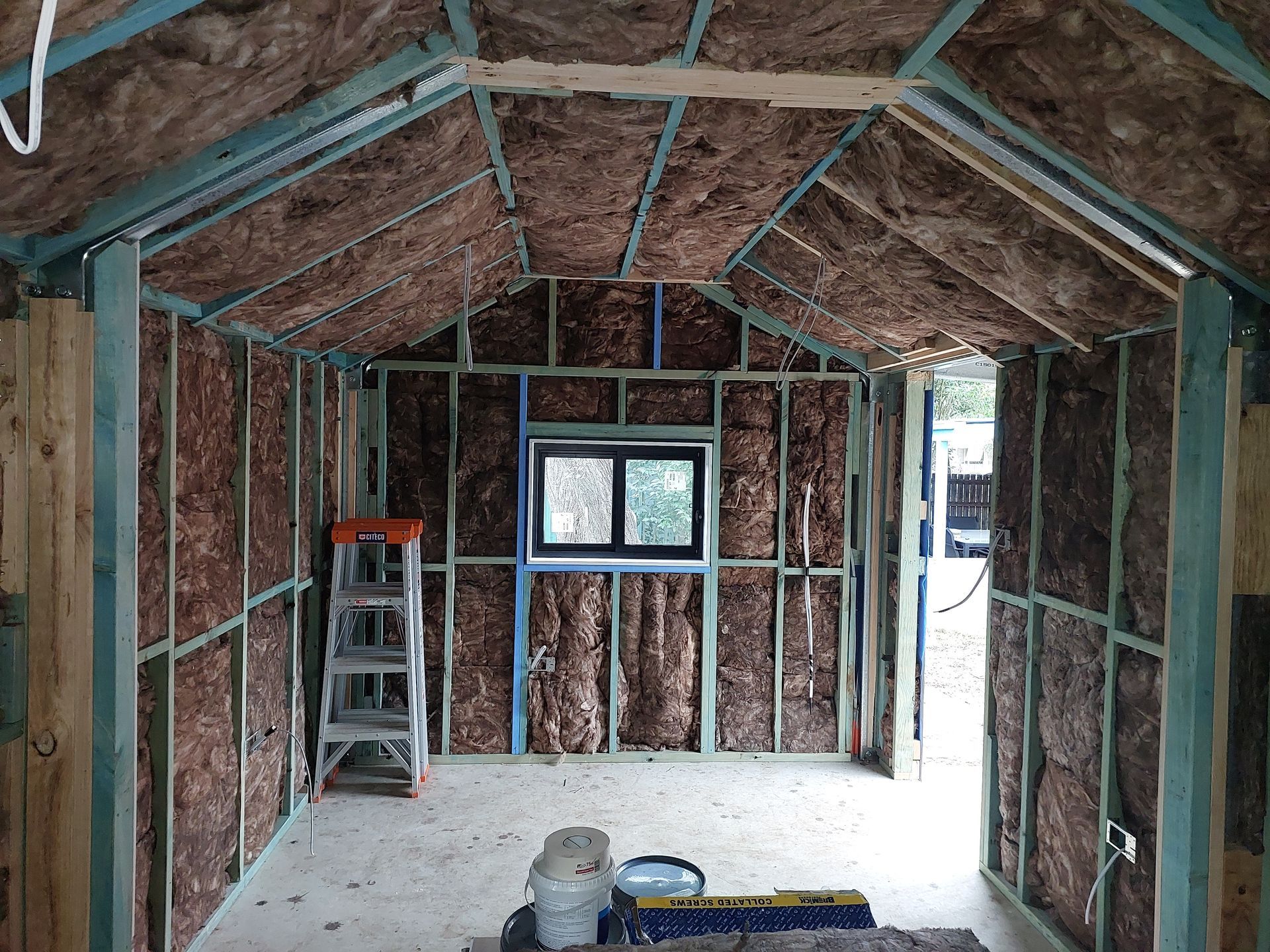 Interior View of a Building Under Construction, With Insulated Walls, a Window, and a Ladder — Elimar Construction in Goulburn, NSW