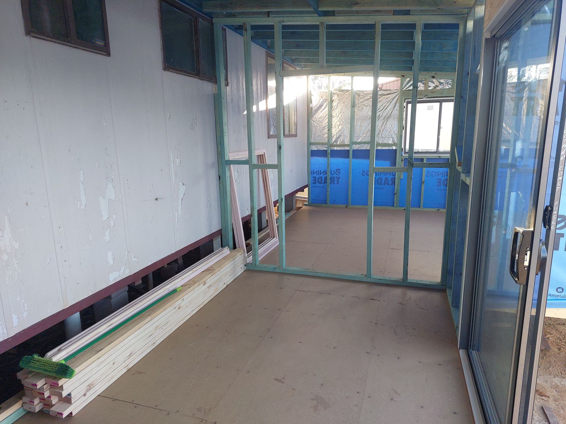 Interior of a Building Under Construction, Showing Framing, Blue Insulation, and an Open Doorway — Elimar Construction in Goulburn, NSW