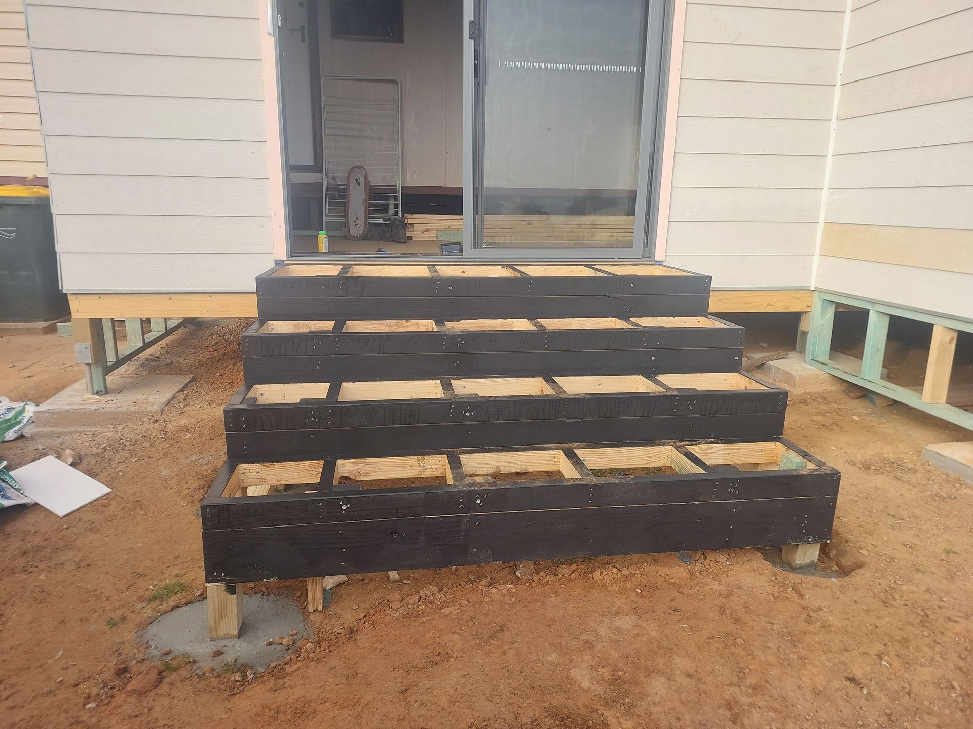 Dark Wooden Steps Leading to a Sliding Door, Built on a Sandy Ground — Elimar Construction in Goulburn, NSW