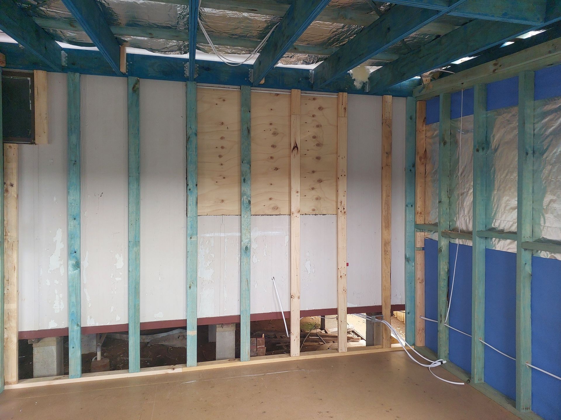 Interior Room Under Construction, With Wooden Frame Walls, Insulation, and Exposed Ceiling Beams — Elimar Construction in Goulburn, NSW