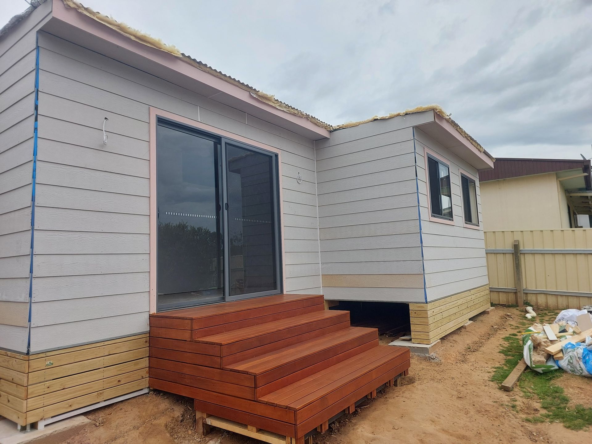 Red steps Coming out From A Door— Elimar Construction in Goulburn, NSW