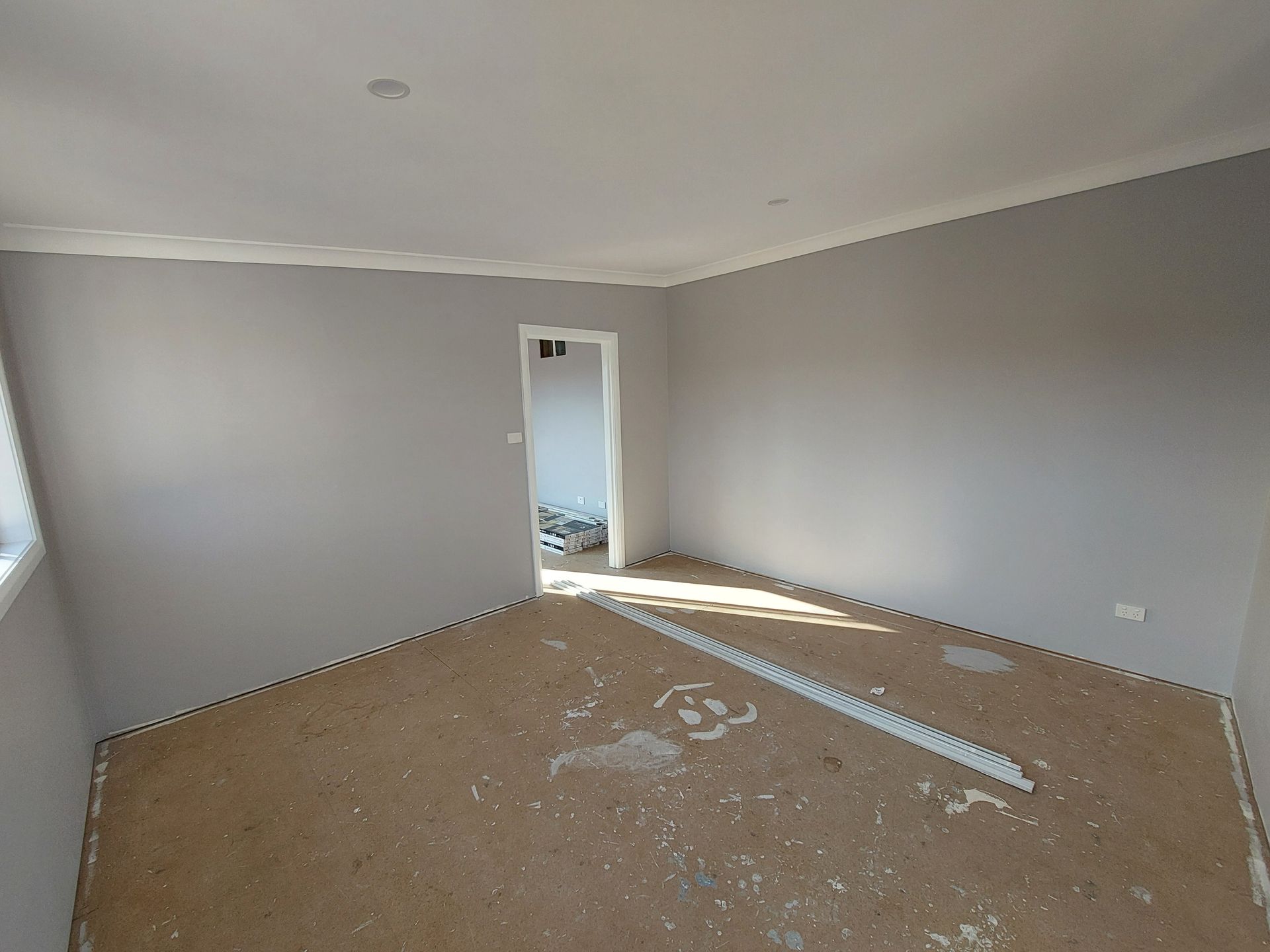 Empty Room With Gray Walls and a Doorway, Unfinished Flooring — Elimar Construction in Goulburn, NSW