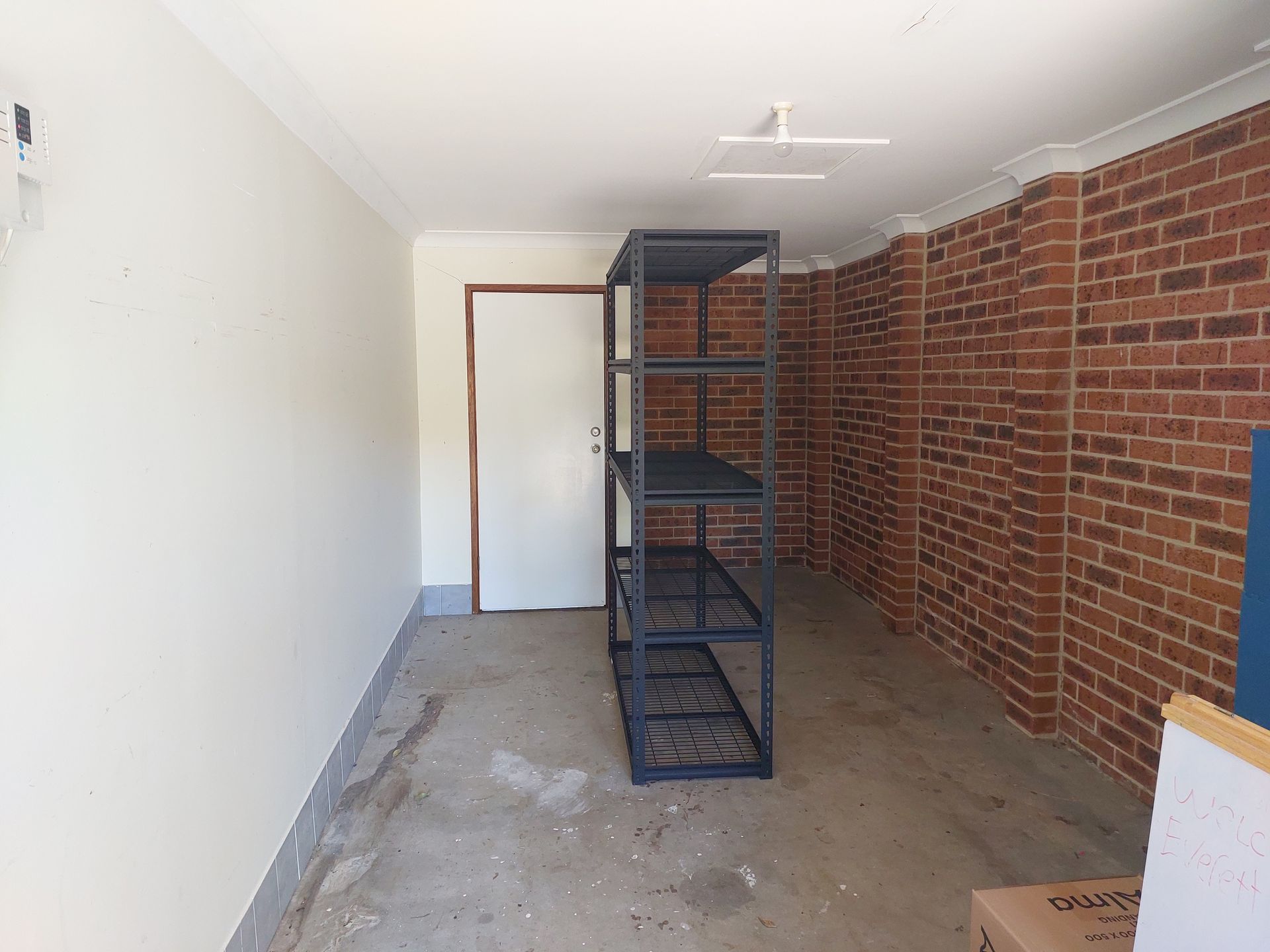 A Ladder is Going Up to the Attic in a Garage Filled With Lots of Bikes — Elimar Construction in Goulburn, NSW