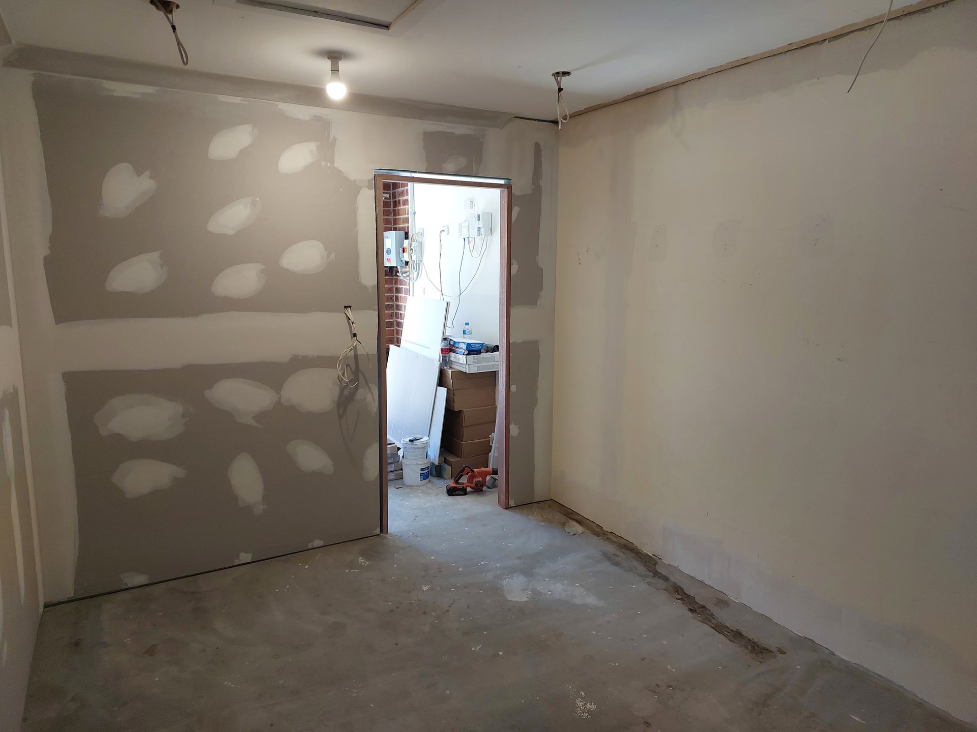 Room Interior During Construction, With Drywall, Unfinished Walls, and an Open Doorway — Elimar Construction in Goulburn, NSW