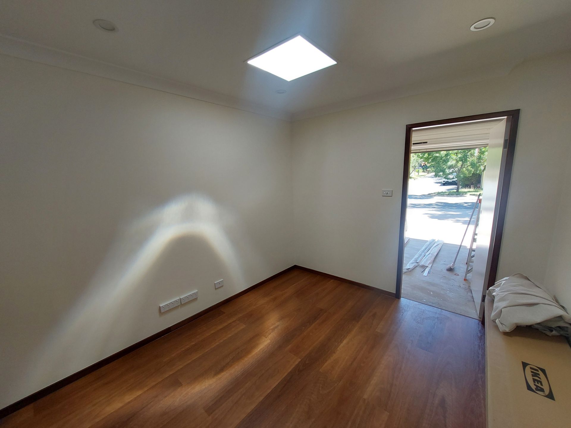 Empty Room With Wood Floors, Bright Light, and Open Doorway to Outdoors — Elimar Construction in Goulburn, NSW