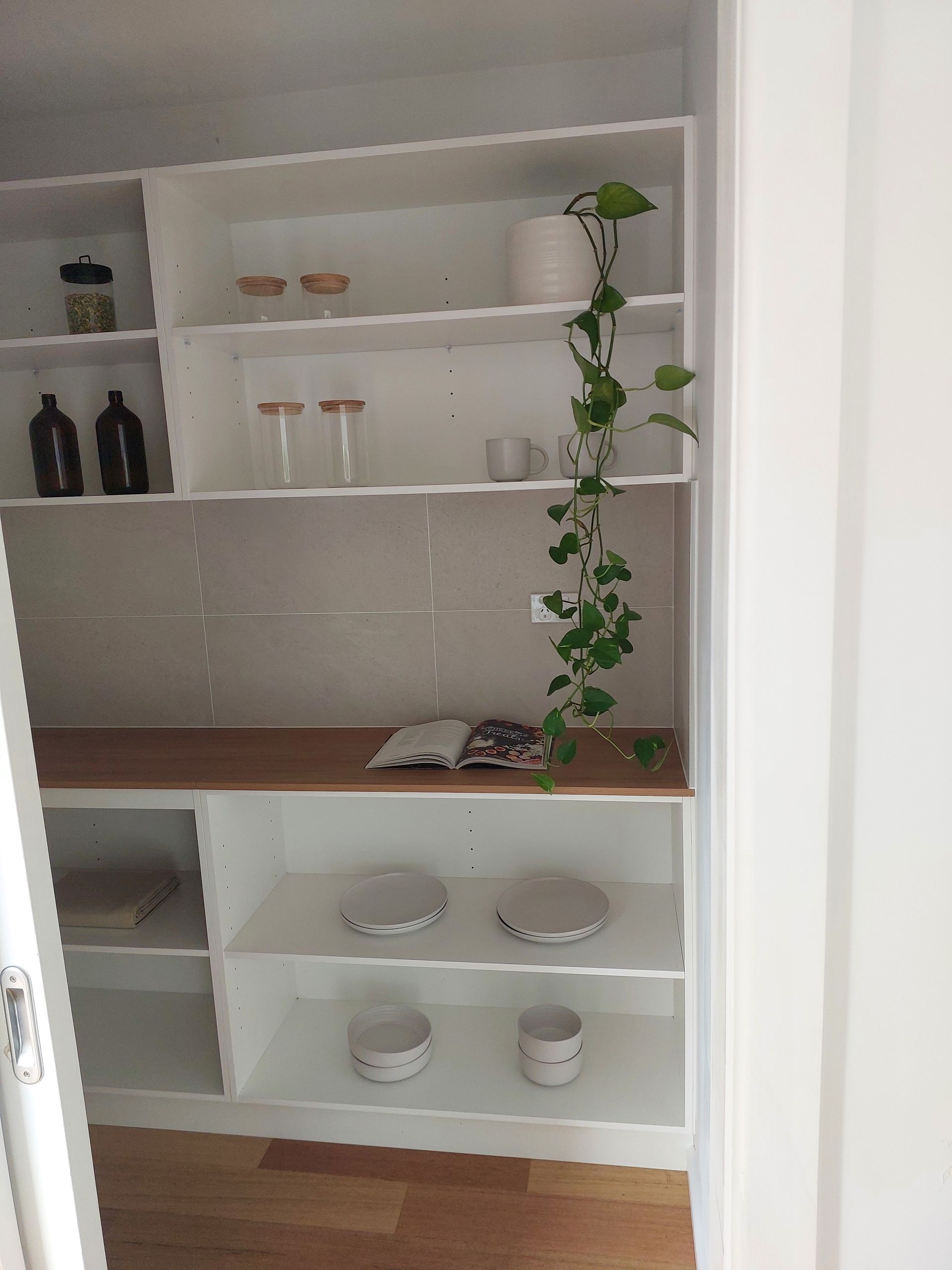 White Pantry Shelves With Various Items, Including Plants, Containers, and Plates — Elimar Construction in Goulburn, NSW