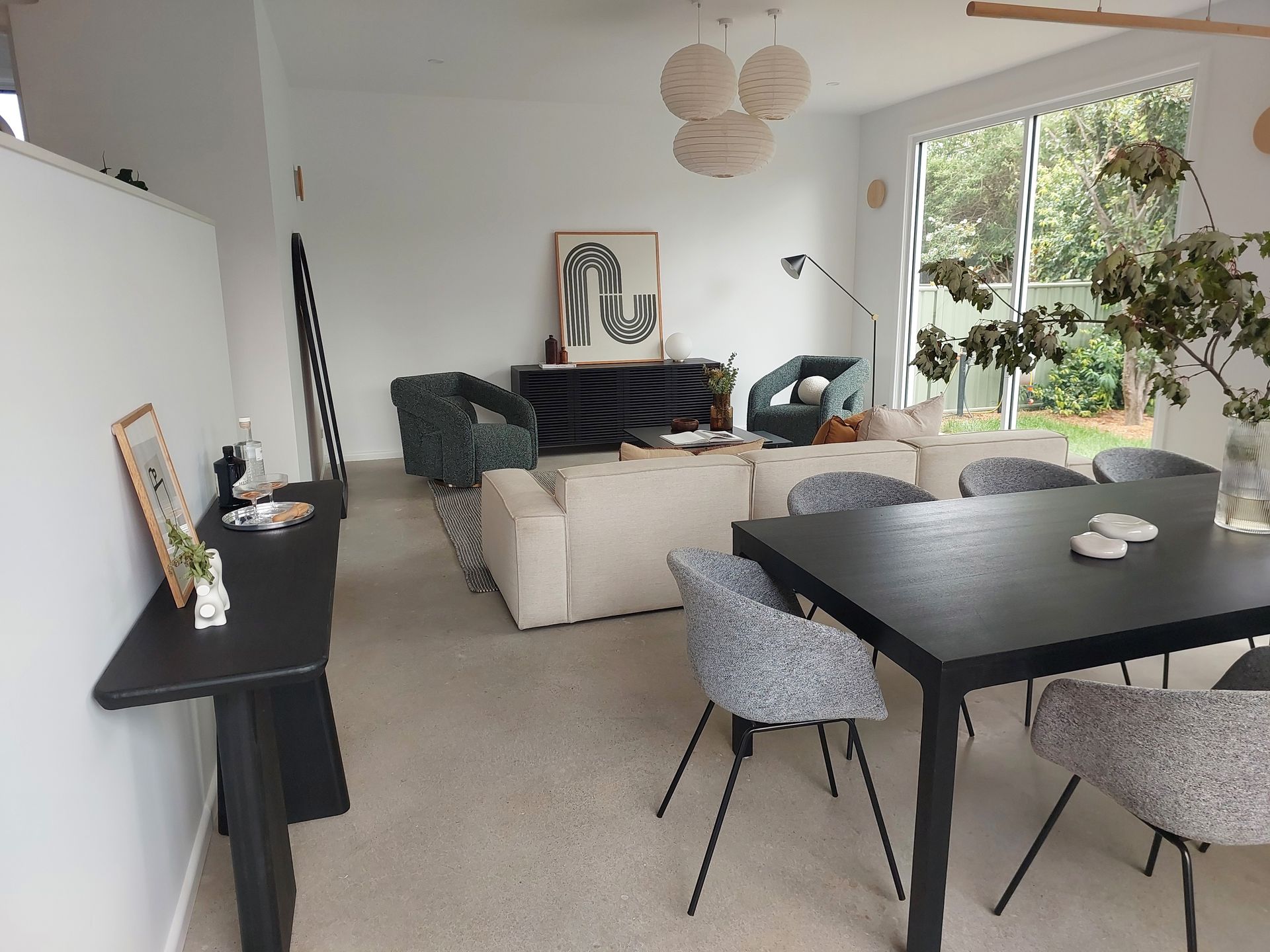 Living Room With Sofa, Dining Table, Chairs, Art, and Windows — Elimar Construction in Goulburn, NSW