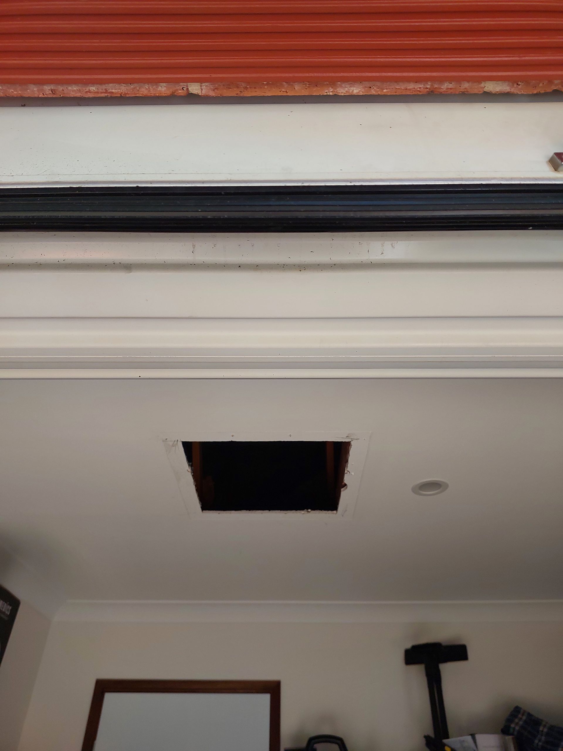 Ceiling With a Large Square Hole, Revealing Space Above; Garage Door Above — Elimar Construction in Goulburn, NSW