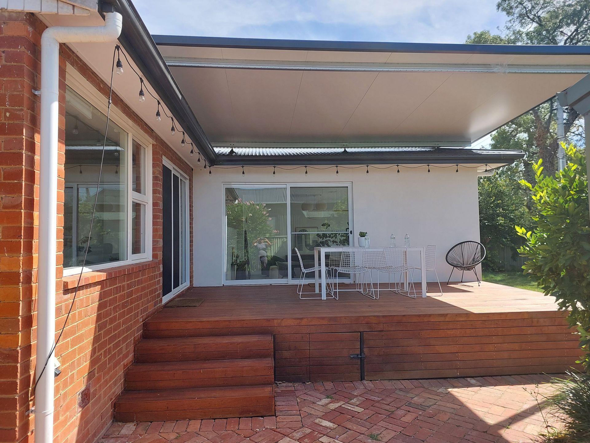 A Brick House With a Patio and a Table and Chairs on It — Elimar Construction in Goulburn, NSW