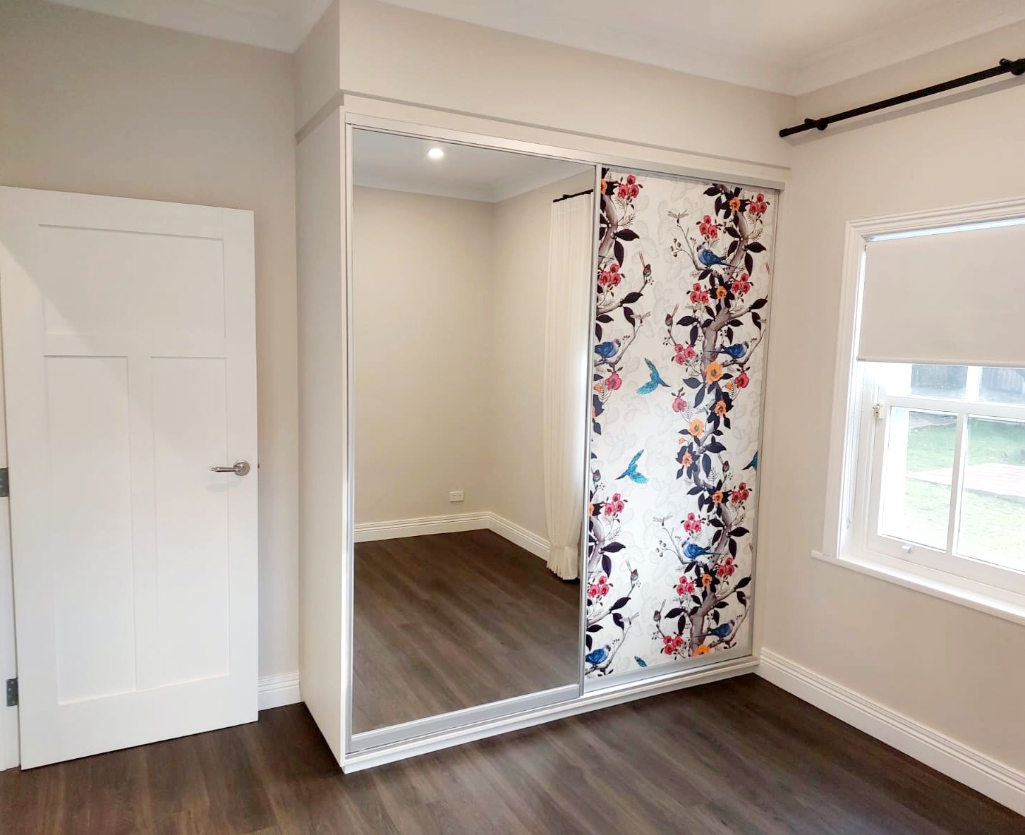 Bedroom With White Wardrobe, Patterned Sliding Door, Mirror, and a White Door to the Left  — Elimar Construction in Goulburn, NSW