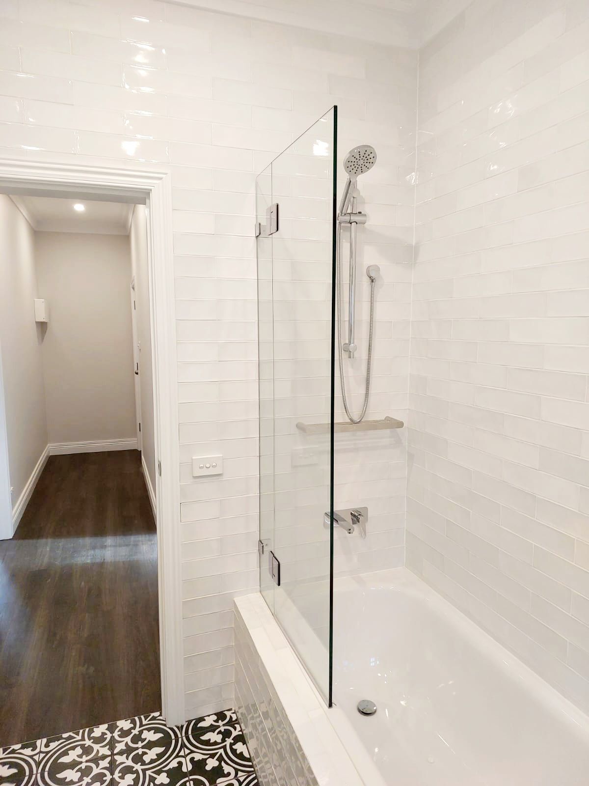 White Bathroom With Glass Shower Screen, Shower Head, and Bathtub  — Elimar Construction in Goulburn, NSW