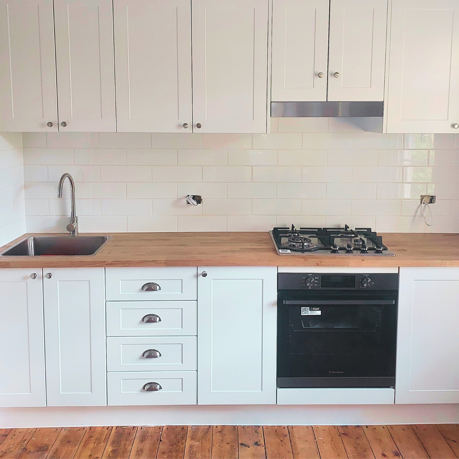 White Kitchen With Wooden Countertops — Elimar Construction in Braidwood, NSW