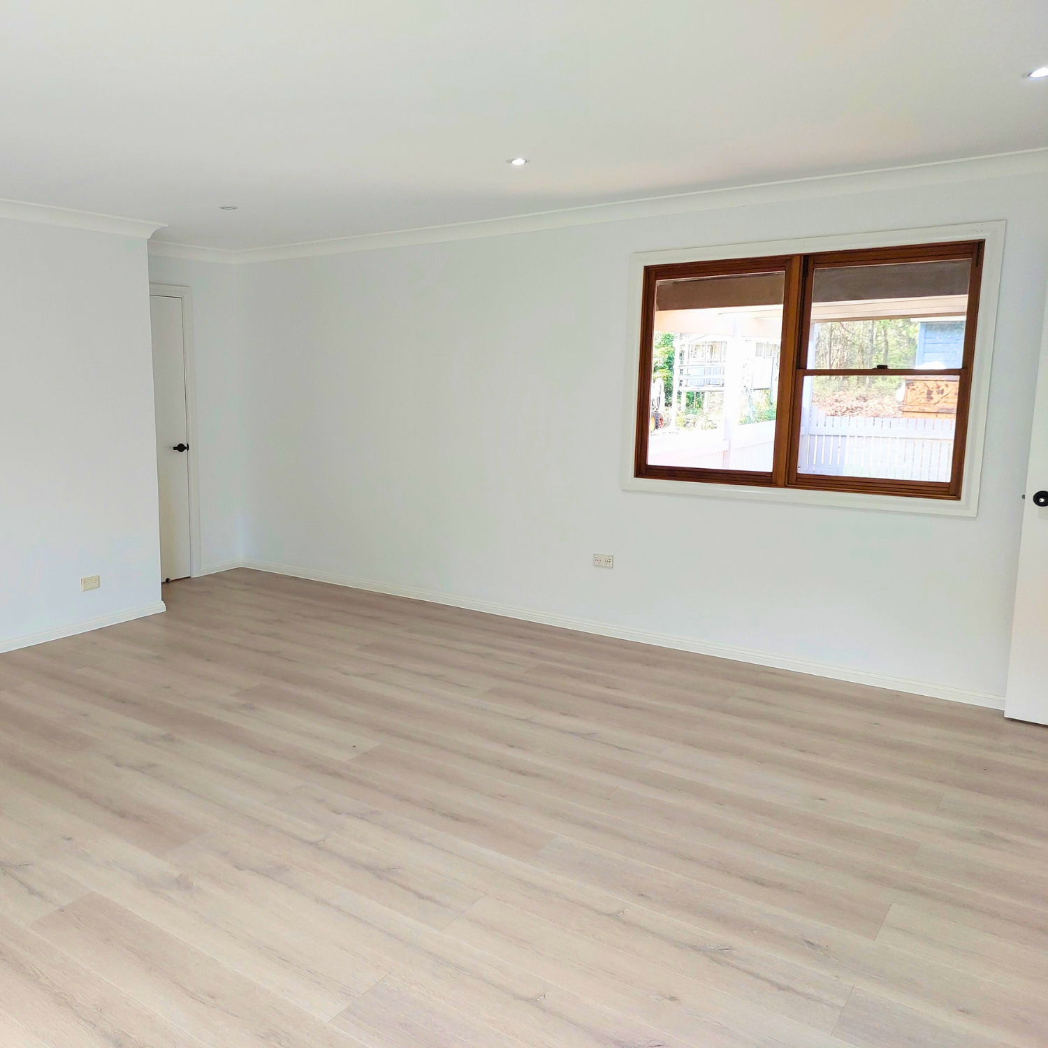Empty Room With Light Wood Floors, White Walls, and a Window — Elimar Construction in Braidwood, NSW