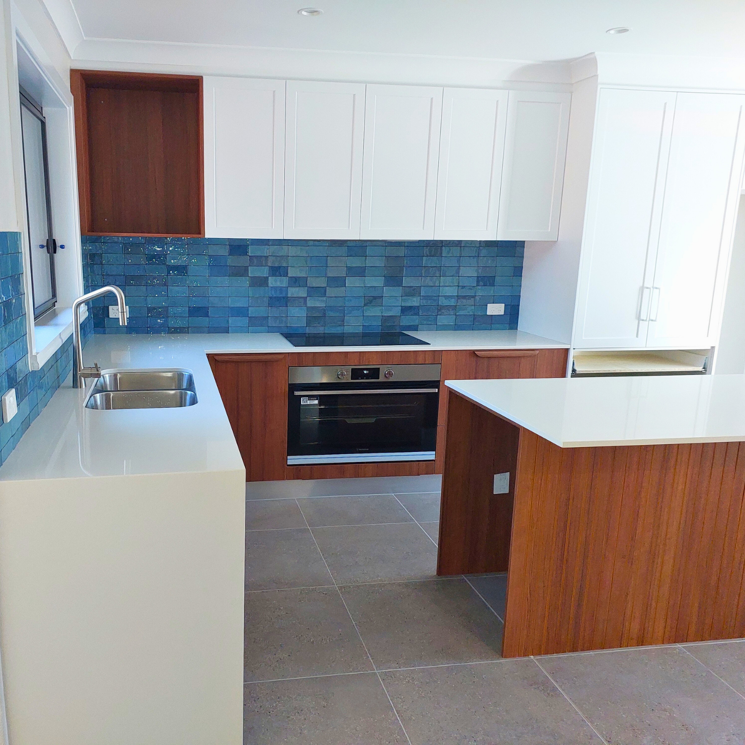 Newly Renovated Kitchen With Blue Tile Splashback — Elimar Construction in Goulburn, NSW