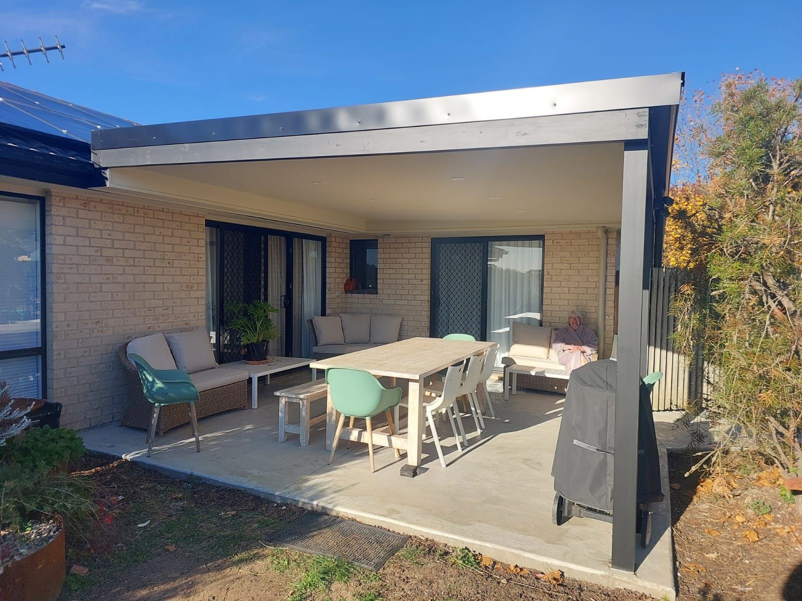 Covered Outdoor Patio With Seating and Dining Area; Light Brick Home — Elimar Construction in Goulburn, NSW
