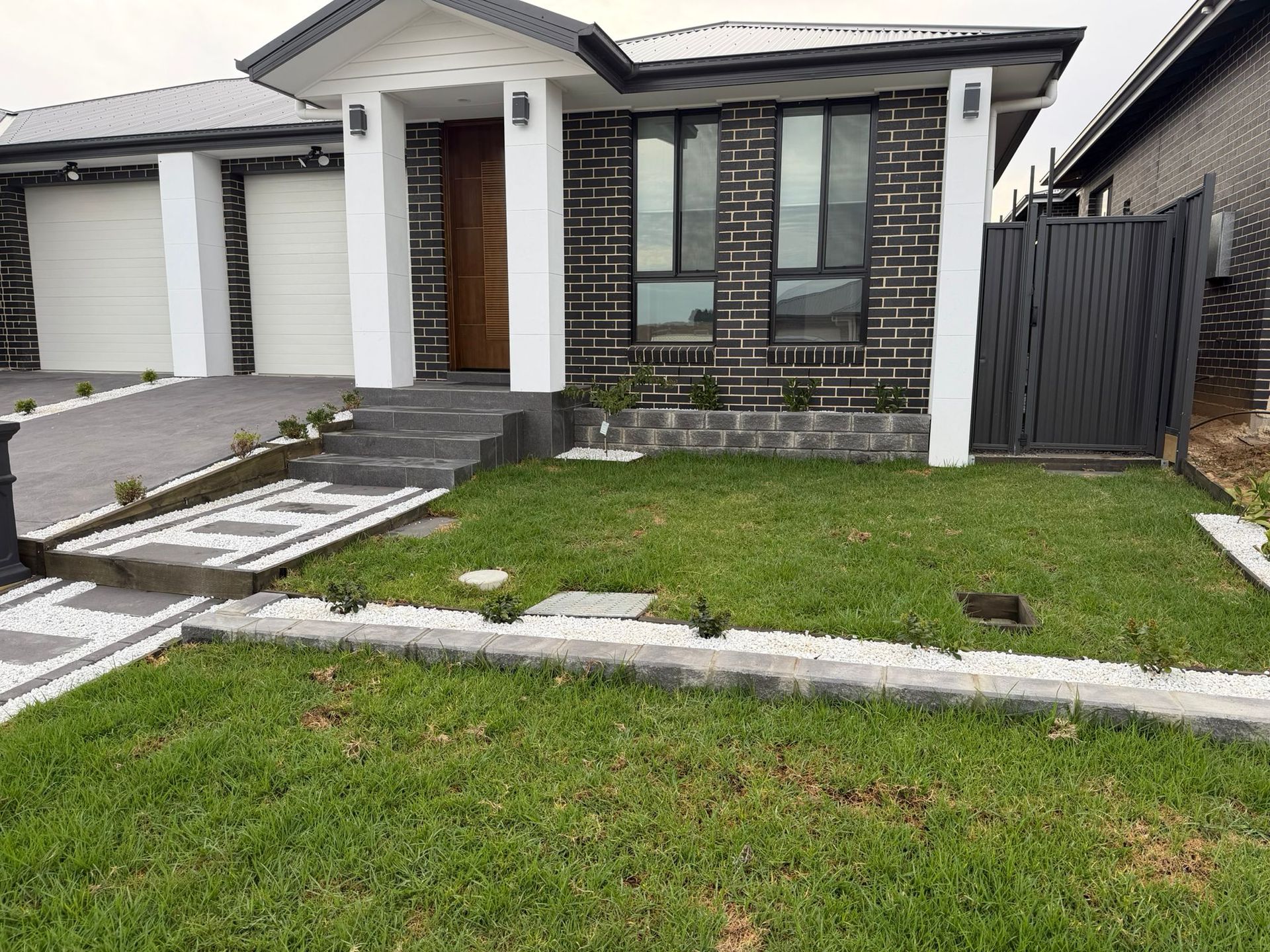 Modern single-story house with gray brick facade, white trim, driveway, and  — Elimar Construction in Goulburn, NSW