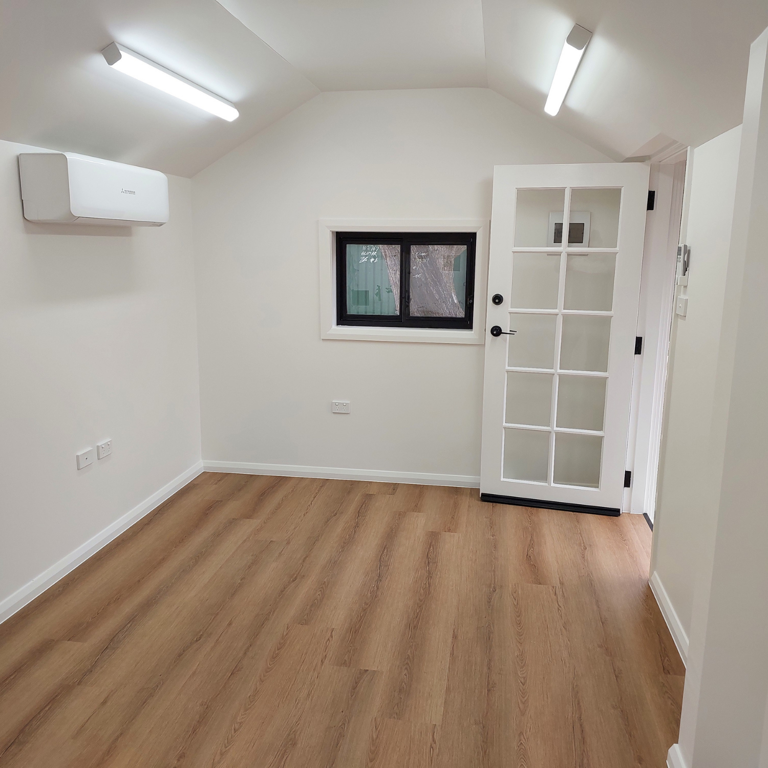 Interior of a Small, White Room With Wood-look Flooring — Elimar Construction in Goulburn, NSW