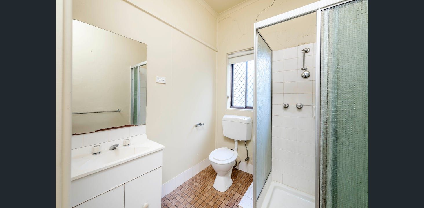 Bathroom With Shower, Toilet, and Vanity. Off-white Walls, Tiled Floor, and a Window in the Center  — Elimar Construction in Goulburn, NSW