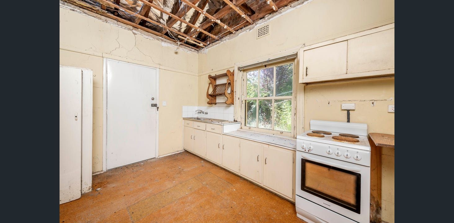 Kitchen With Damaged Ceiling, Cabinets, and Appliances  — Elimar Construction in Goulburn, NSW