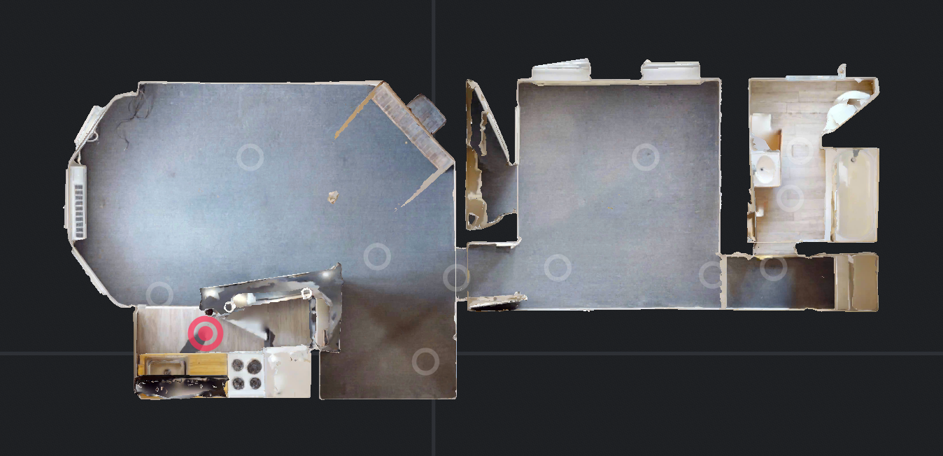 Floor plan of a house, with kitchen, living room, and bedroom, in shades of gray and brown.