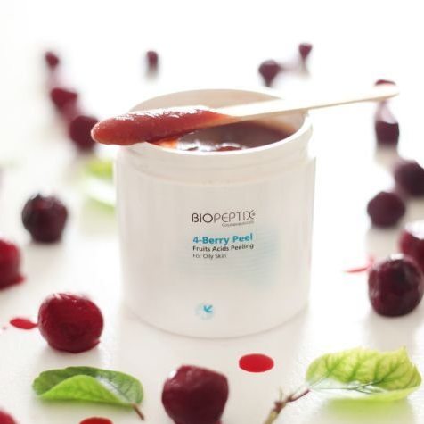 A jar of biopeptide 4 berry peel with a spoon in it