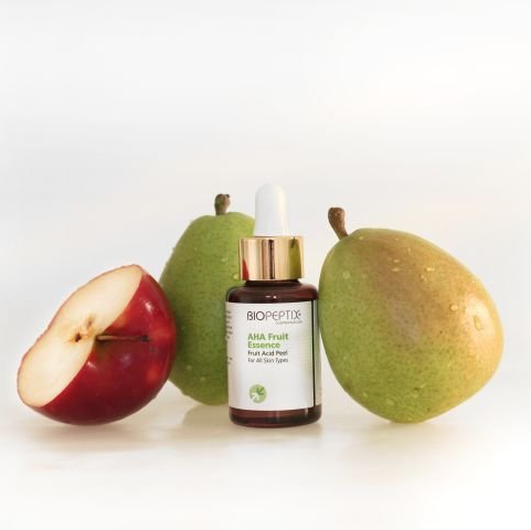 A bottle of biopeptide next to apples and pears