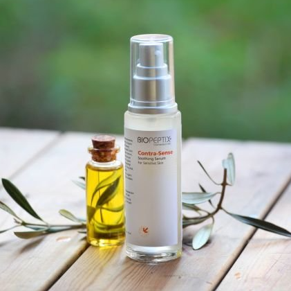 A bottle of biocosmetic sitting on a wooden table