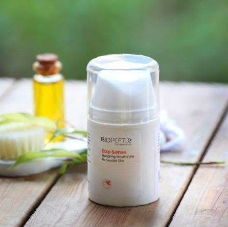A bottle of biosepte lotion is sitting on a wooden table
