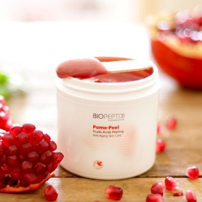 A jar of biopeptide pome-peel with a spoon in it