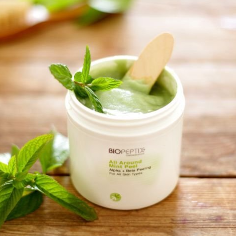A jar of biopeptide all around mint peel with a spoon in it