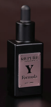 A bottle of kb pure formula y is sitting on a table