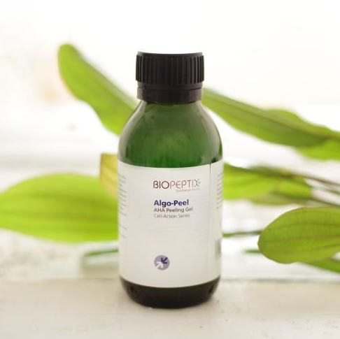 A bottle of biopeptix algo-peel is sitting on a table