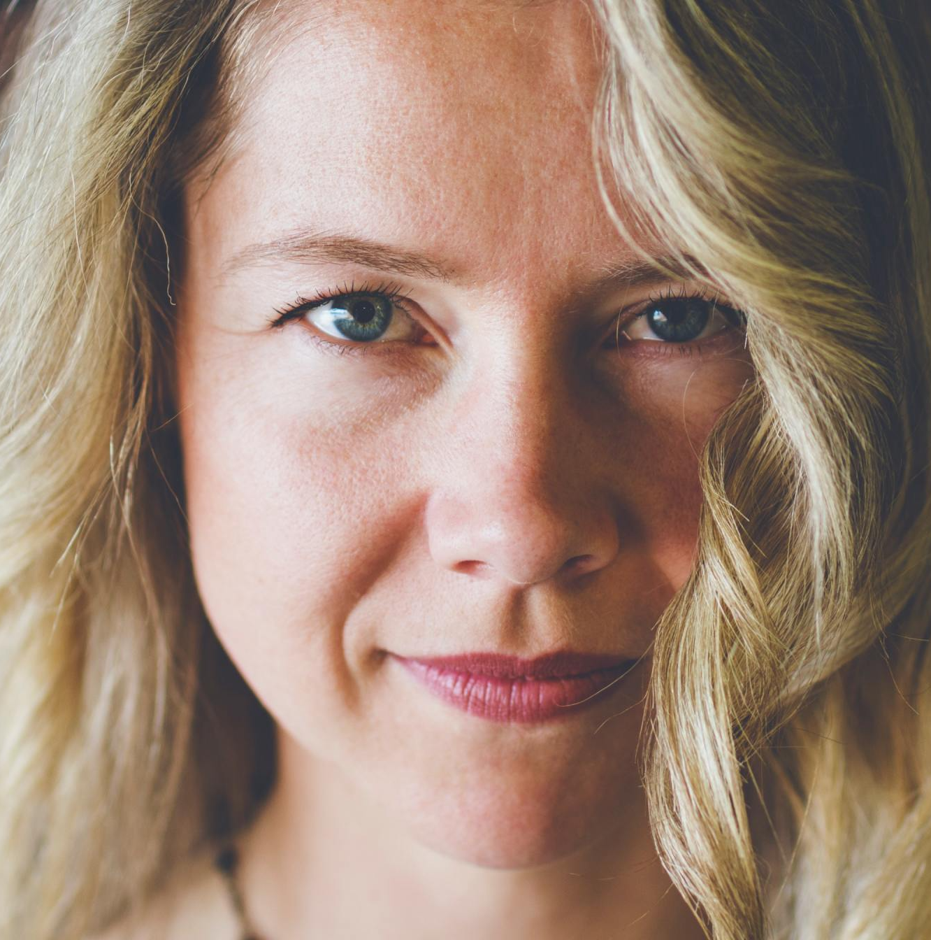 A close up of a woman 's face with blonde hair