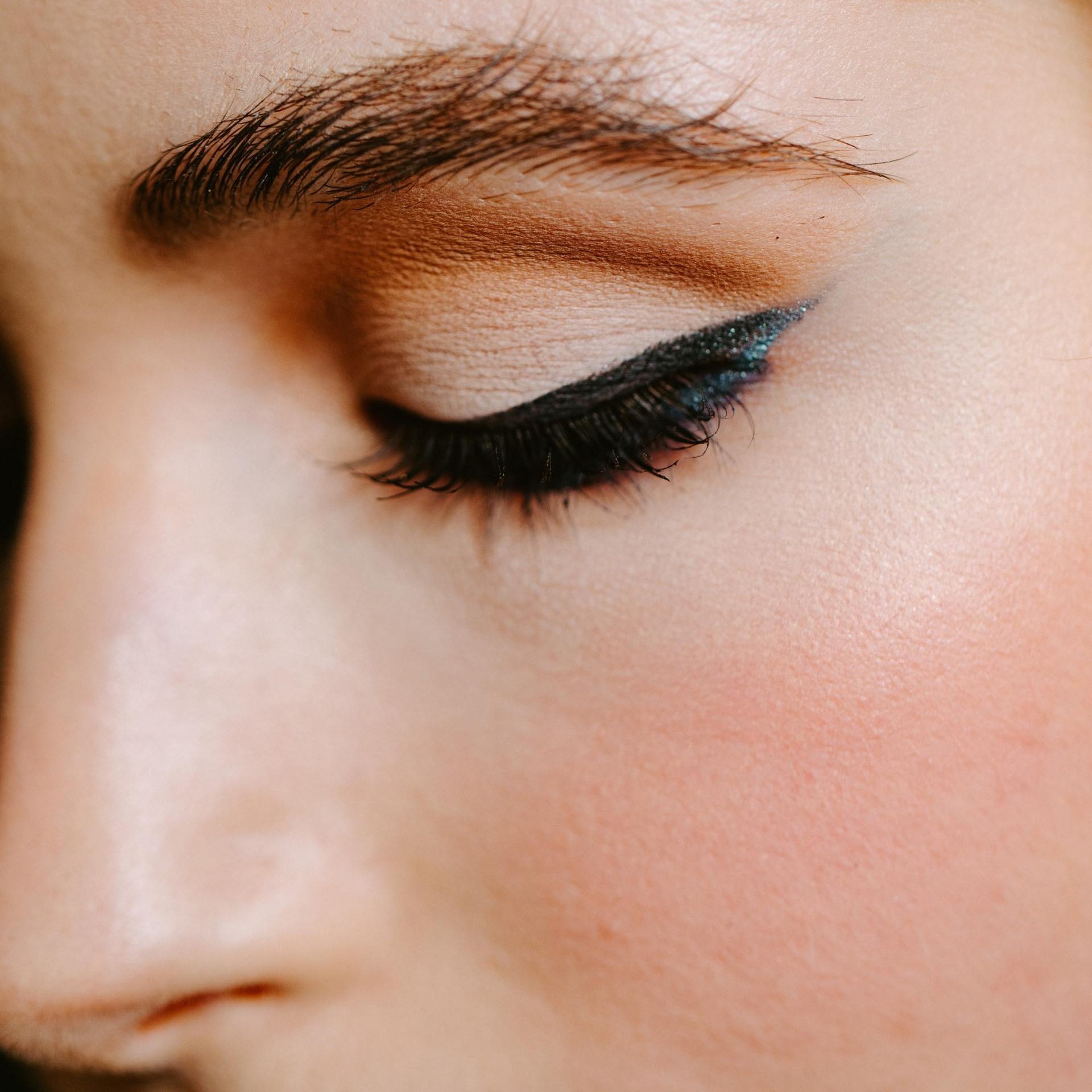 A close up of a woman 's eye with makeup on.