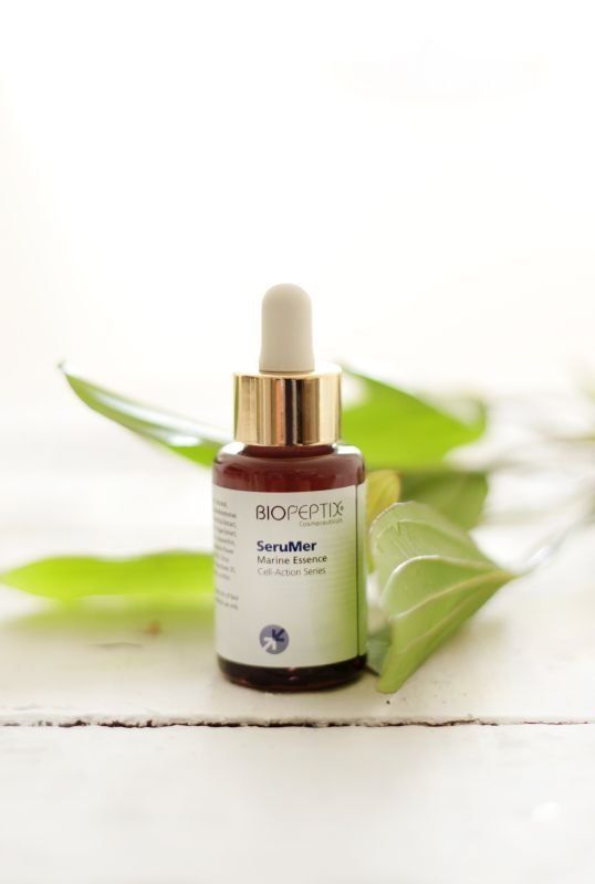 A bottle of biopeptide serum is sitting on a table