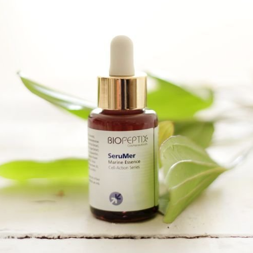 A bottle of biopeptide serum is sitting on a table