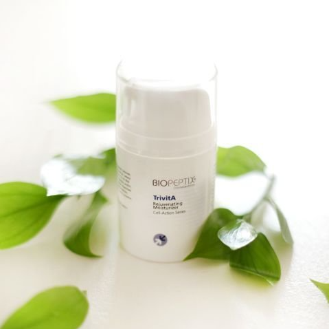 A bottle of biopeptor is surrounded by green leaves