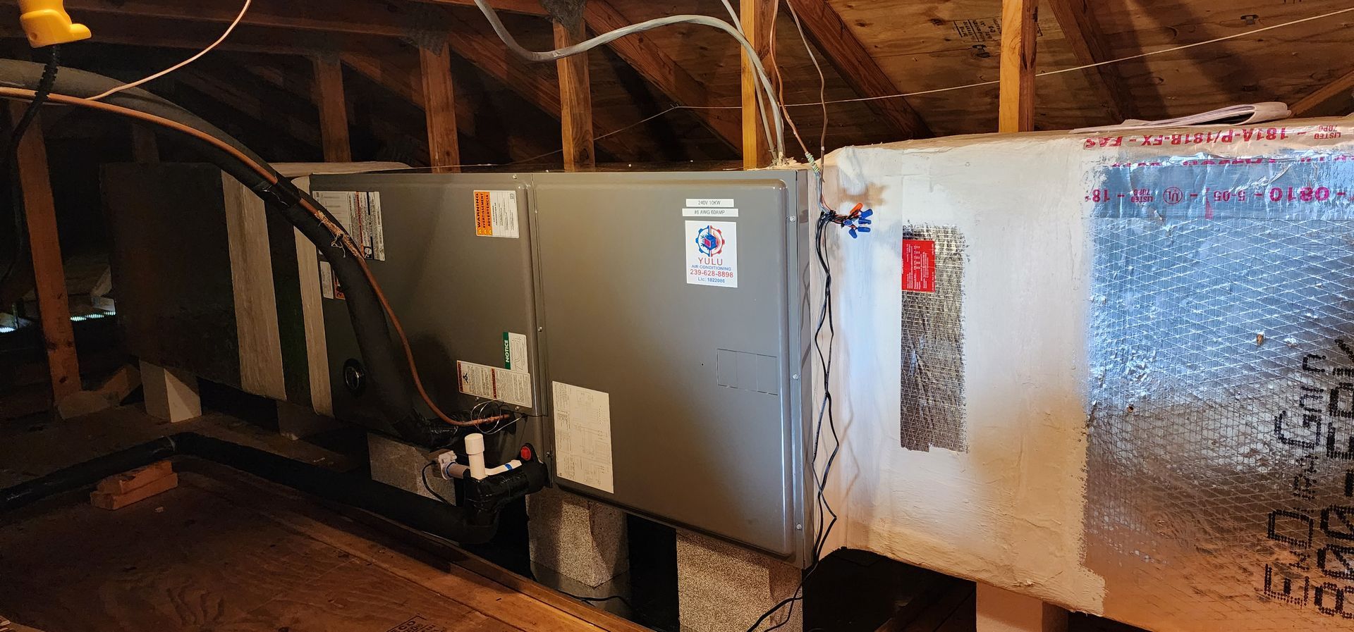 An air conditioner is installed in the attic of a house.