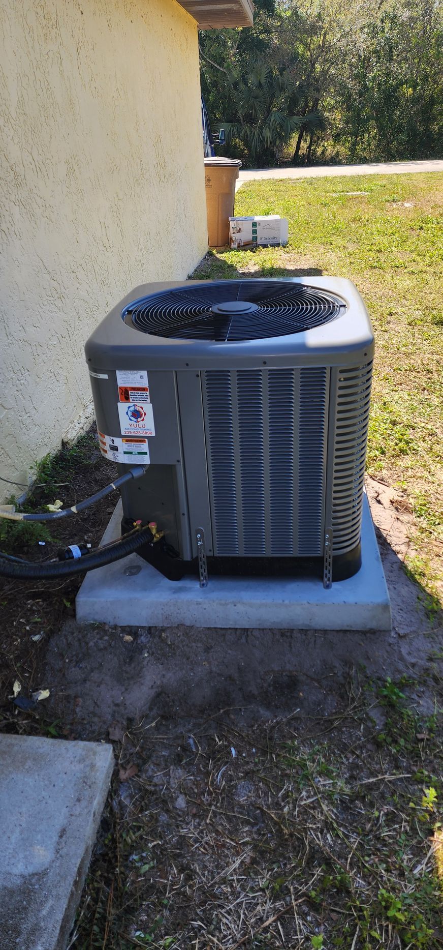 An air conditioner is sitting on the side of a house.