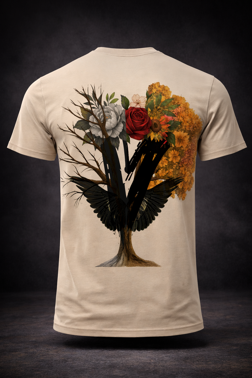 Beige t-shirt with a tree design: branches, flowers, and two black bird-like wings.