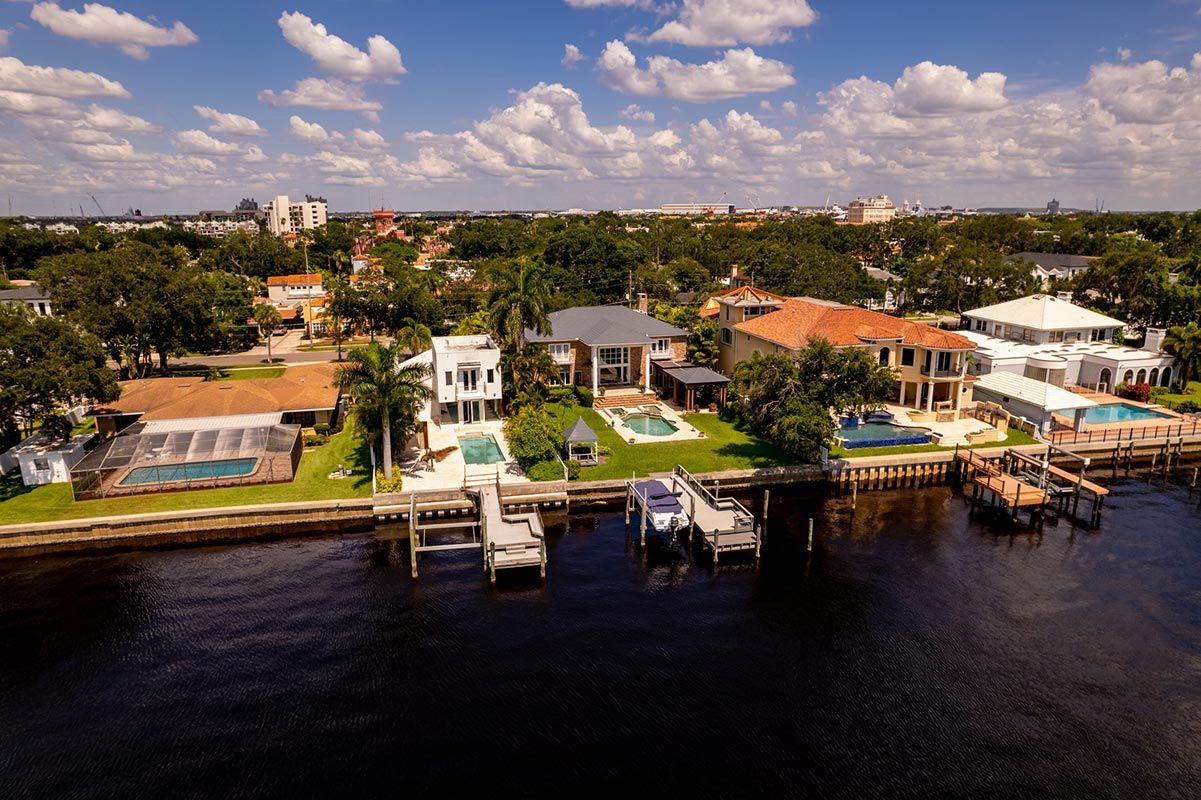 An aerial view of a residential area next to a body of water. An aerial view of a residential area next to a body of water.