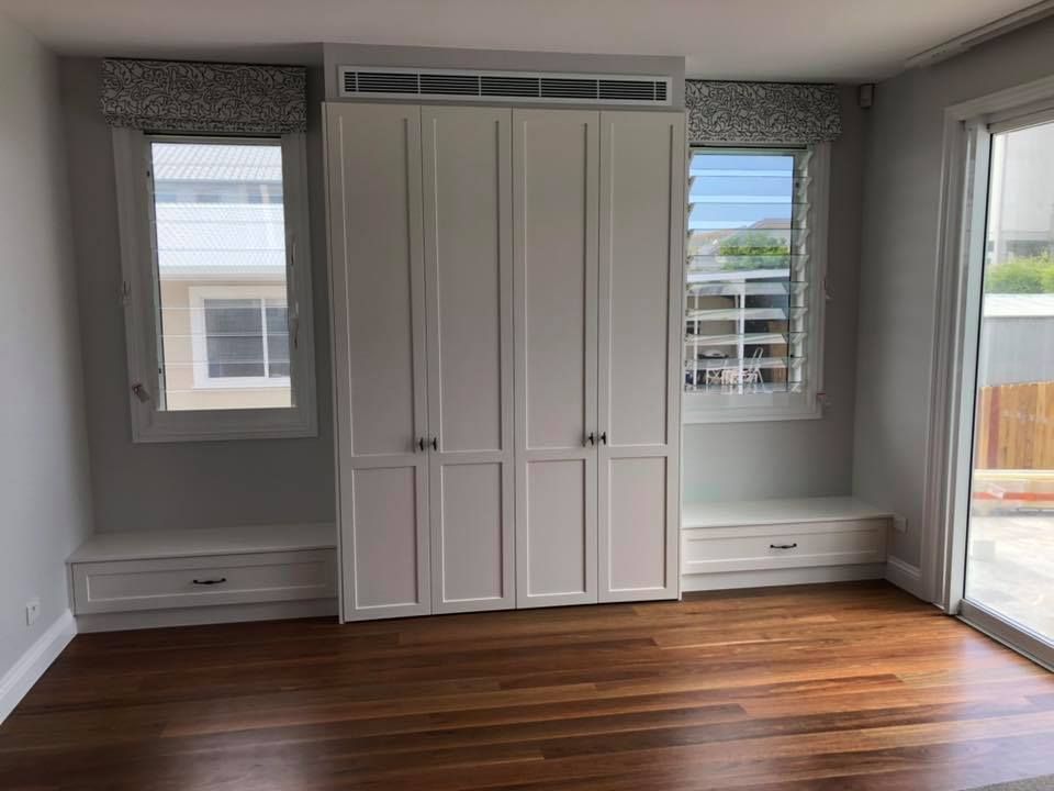 White Built-in Wardrobe Centered Between Two Windows — Platinum Kitchens & Bathrooms in Sawtell, NSW