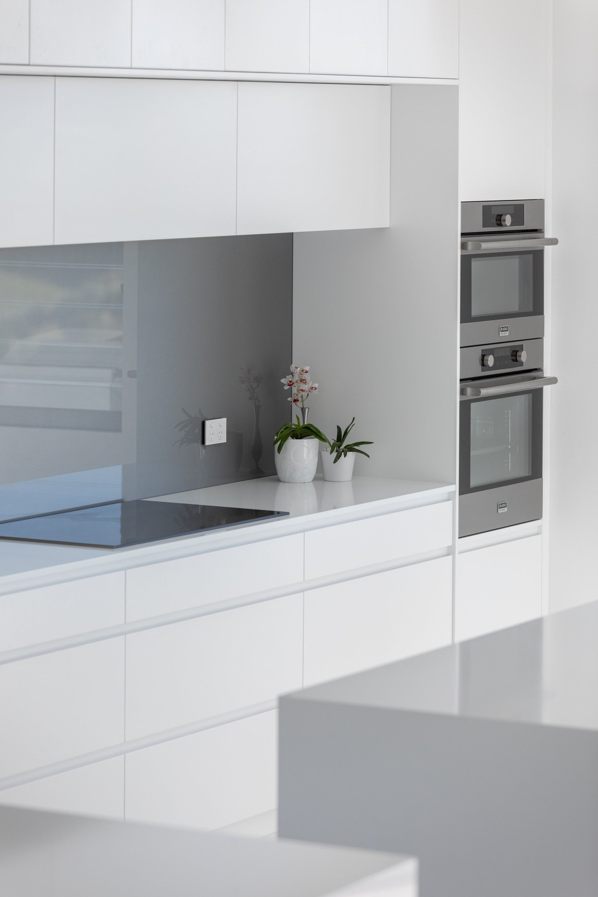 Modern, White Kitchen With Built-in Ovens — Platinum Kitchens & Bathrooms in North Boambee Valley, NSW