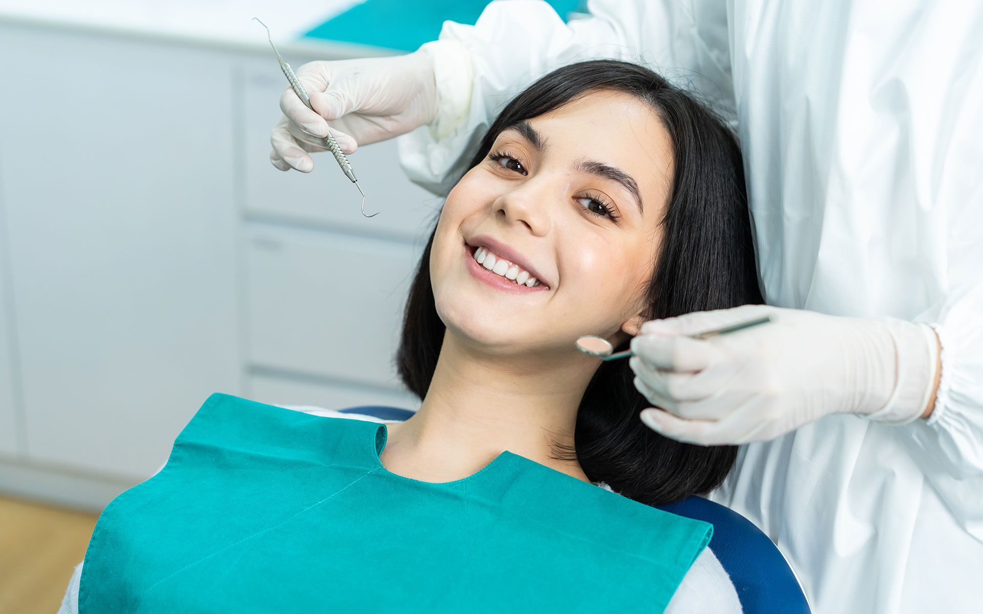 Woman smiling at dentist during dental examination.