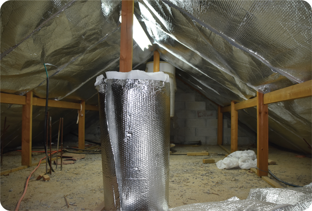 An attic with aluminum foil covering the ceiling