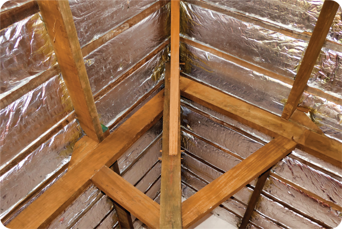 A wooden structure with aluminum foil on the walls and ceiling.
