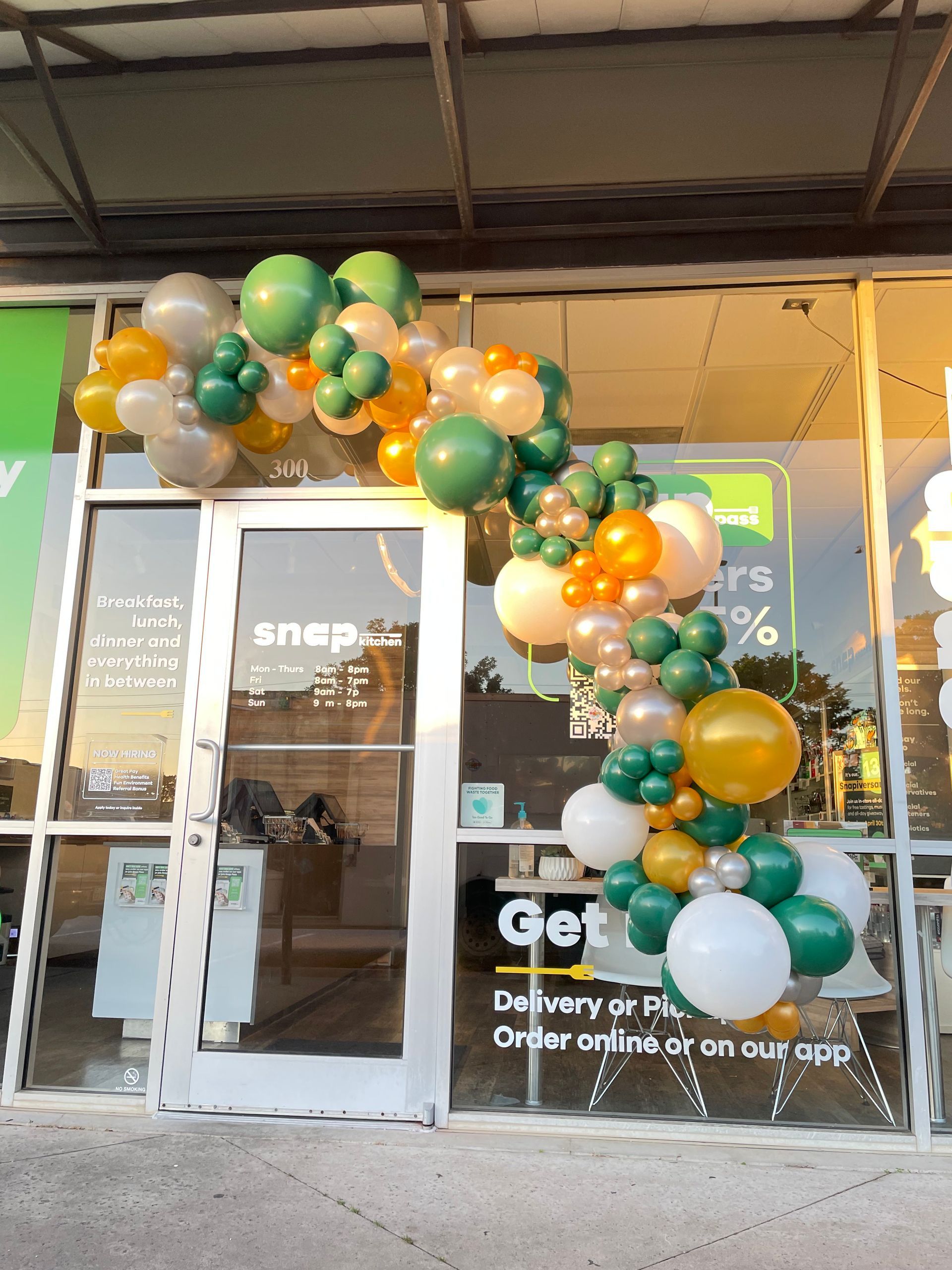 A store front with balloons in front of it